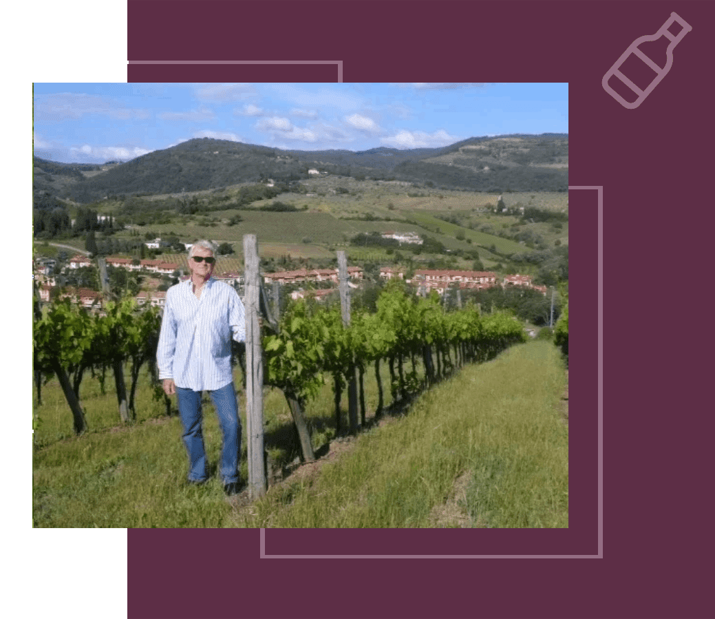 A man standing in front of some vines